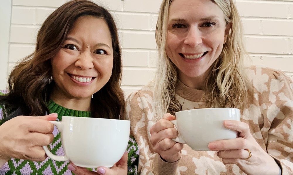 Marlynn Jayme Schotland and Catherine Ryan Gregory holding coffee cups.